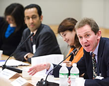 Professor Jan Aart Scholte speaking to the audience at IMF headquarters in Washington DC. In the background, Professor Alnoor Ebrahim and moderator Preeti Shroff-Mehta from the World Bank.