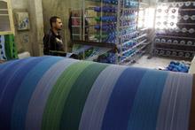 A worker at a textile mill in El-Mahalla El-Kubra, Egypt. Arab transition countries need to spur growth and jobs and promote fairness (photo: Mohamed Abdel-Ghany/Newscom) 